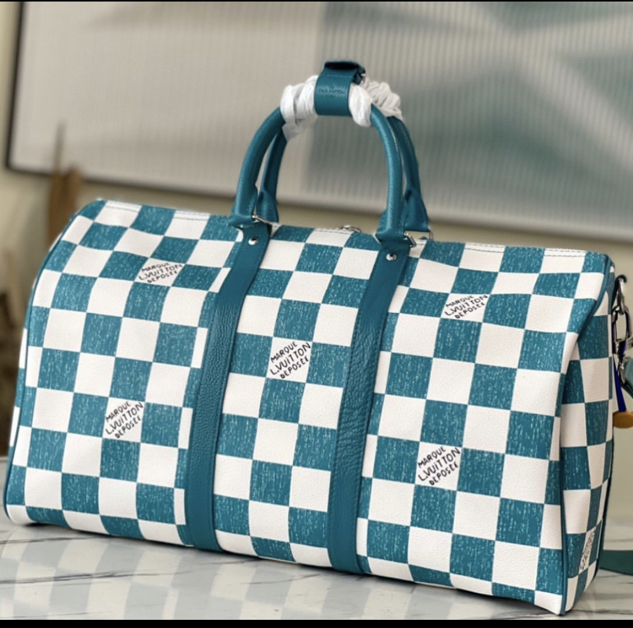LOUIS VUITTON KEEPALL WITH DAMIER CHECKBOARD PATTERN IN TEAL AND WHITE